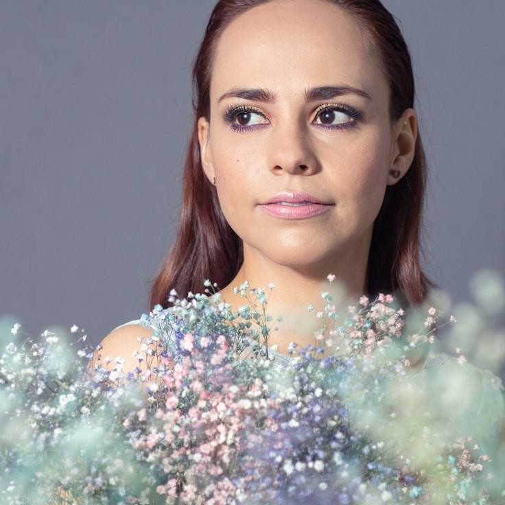 Kaveri Mehta, Lead Design Curator at Island Paper Trail, reviewing corporate floral arrangements